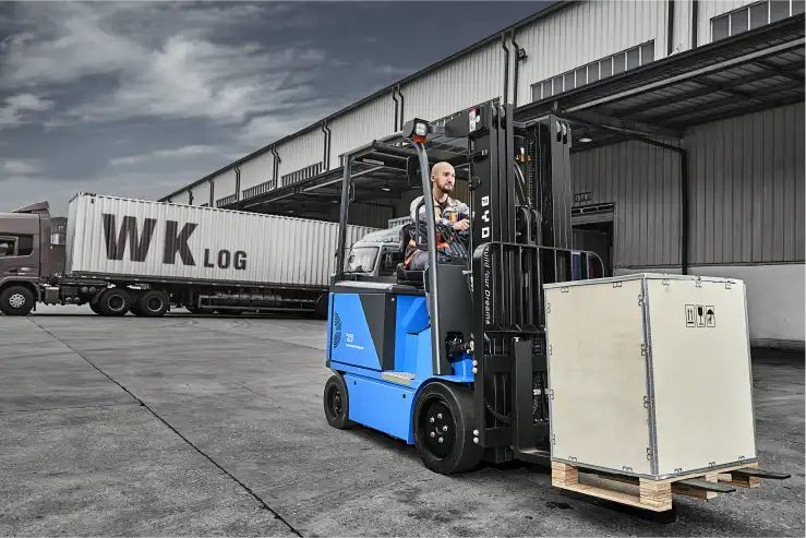 An image of a forklift carrying a large box