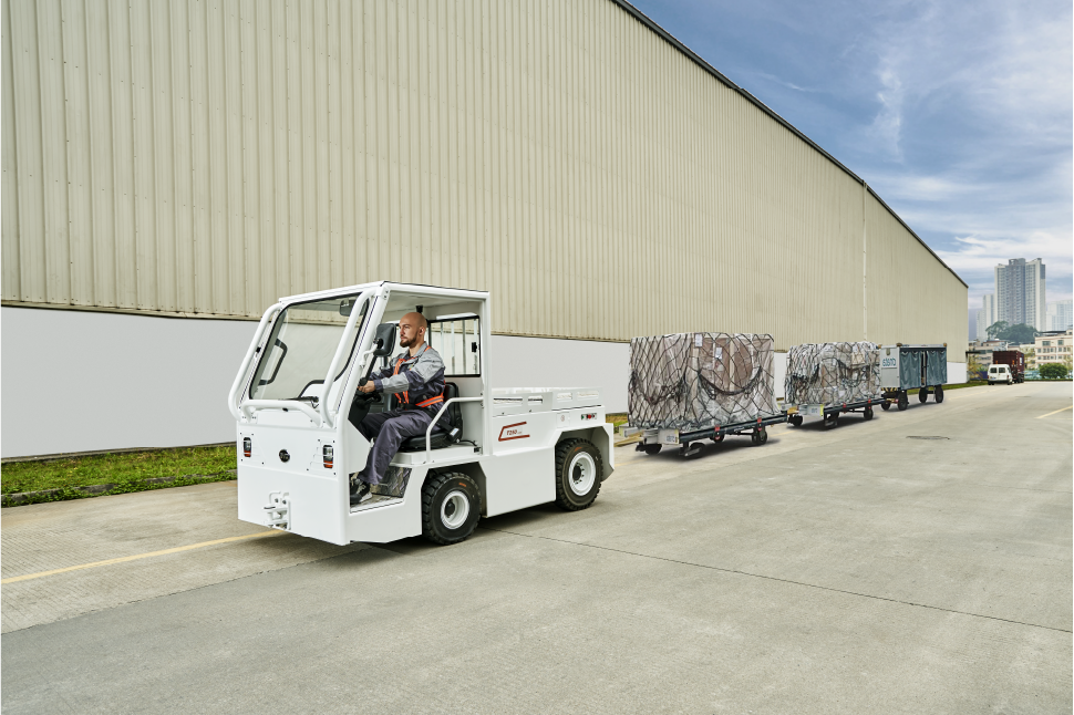 An image of a forklift pulling carts