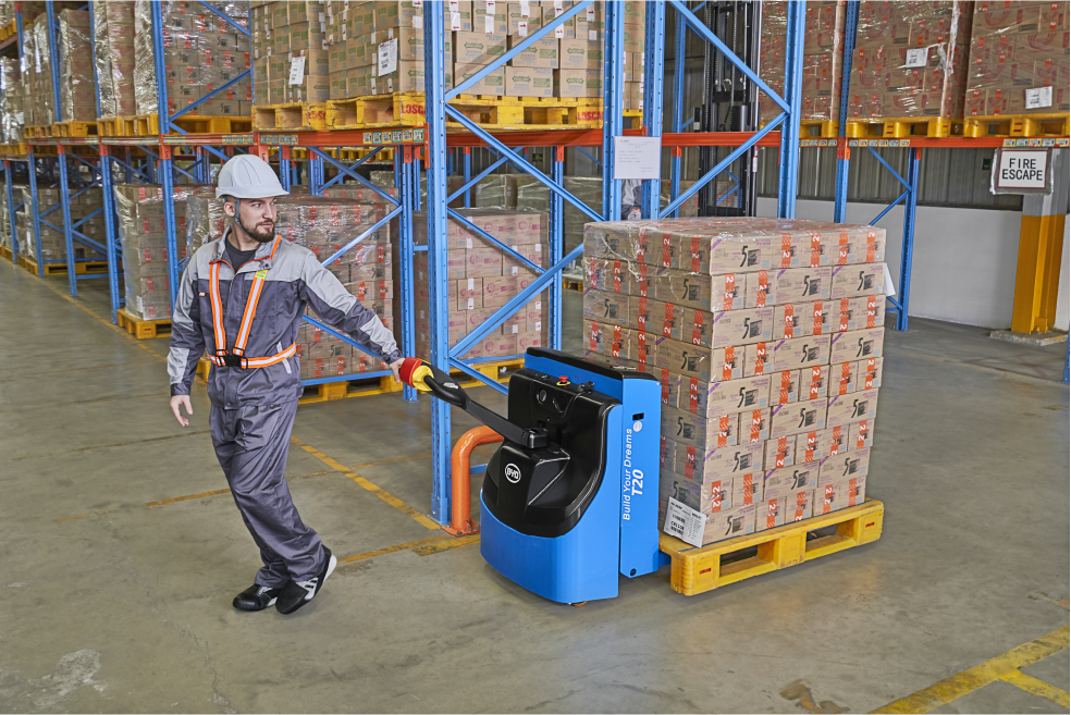 A man pulling stack of boxes using a pallet truck